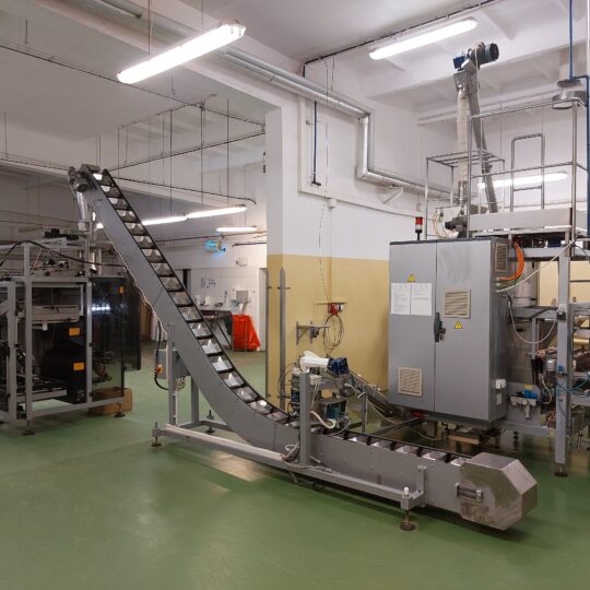 Line for packaging loose products into stick sachets